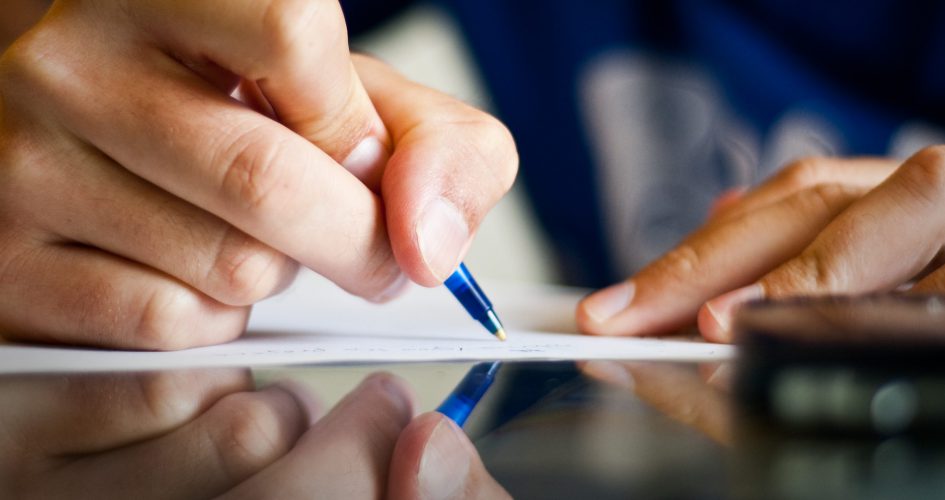 Person writing at a desk